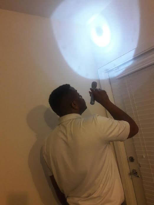 james williams, exterminator in washington dc, inspects a home for bugs